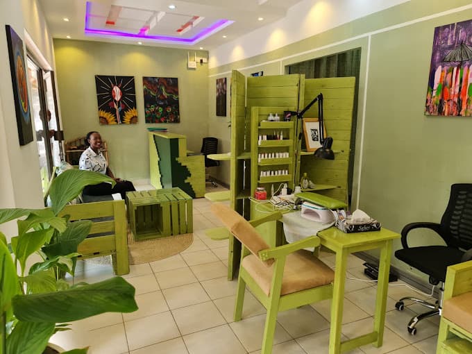 Gallery lounge at Malaika Lotus Spa and Gallery with sage walls, art, and plants