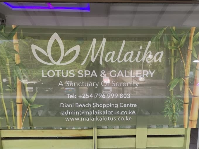 Malaika Lotus Spa and Gallery sign with phone, email, website, and Diani Beach Shopping Centre location